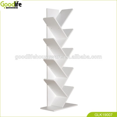 wooden tree shaped bookshelf on corner